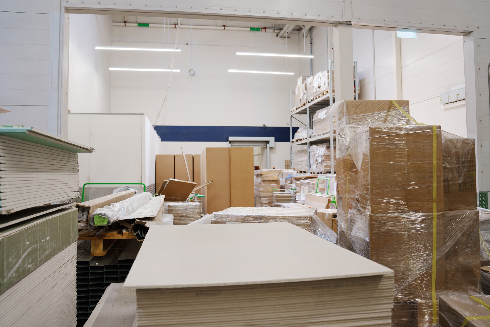 sheets of plywood on a rack in a hardware store.